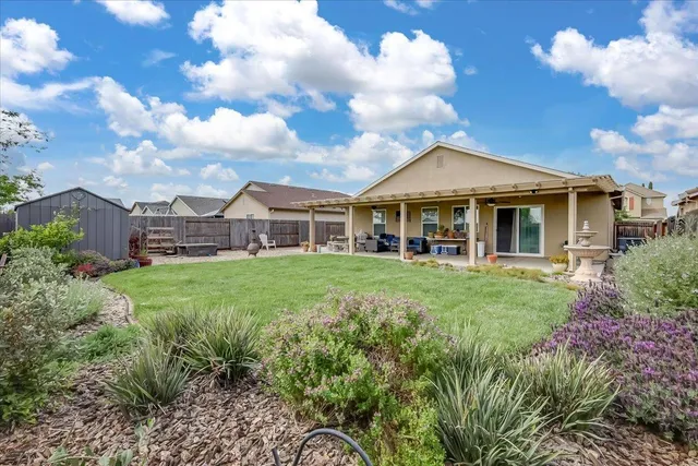 a view of a house with a big yard and large trees