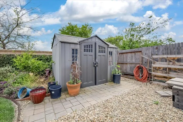 a view of a chair and tables in the patio
