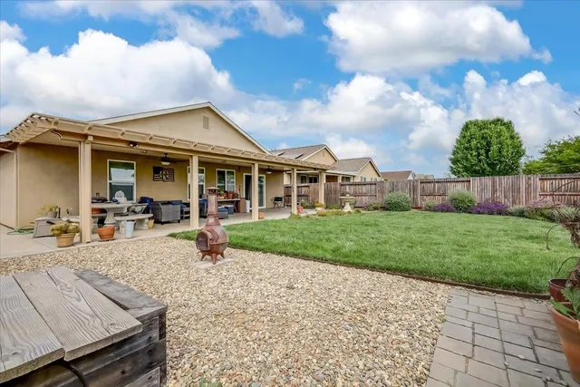 a view of a house with backyard porch and sitting area