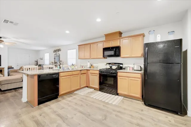 a kitchen with a refrigerator stove and a sink