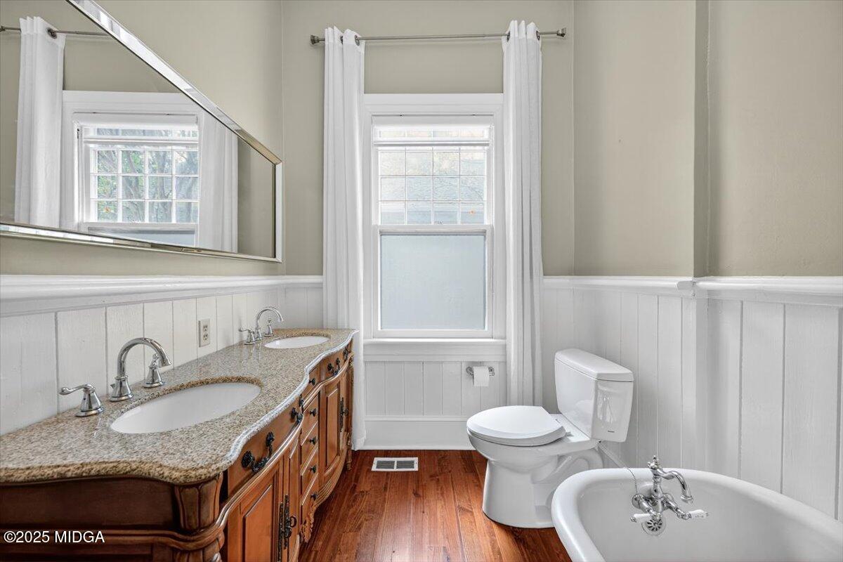 173 Pierce Avenue Macon, GA 31204 - Photo 11 of 20 a bathroom with a granite countertop sink toilet a mirror and shower