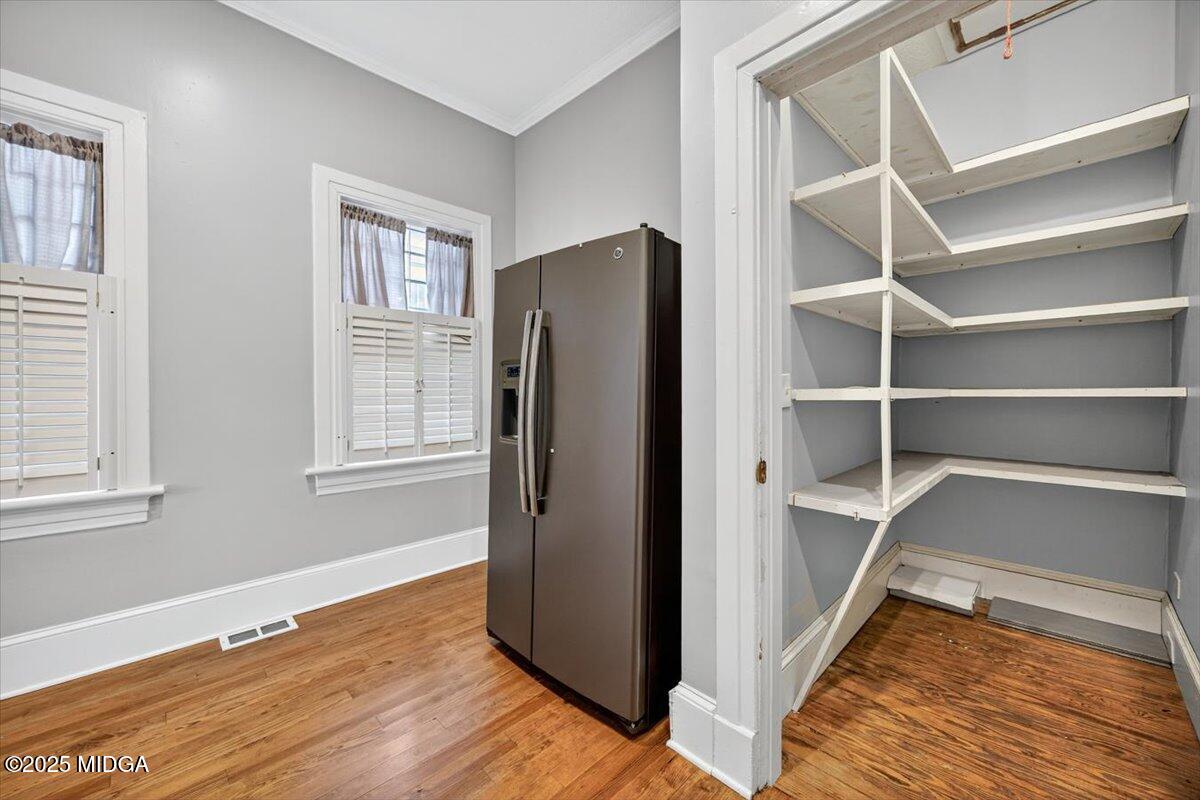 173 Pierce Avenue Macon, GA 31204 - Photo 14 of 20 a view of an empty room with wooden floor and a window