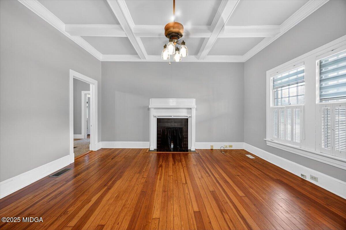 173 Pierce Avenue Macon, GA 31204 - Photo 5 of 20 wooden floor fireplace and windows in an empty room