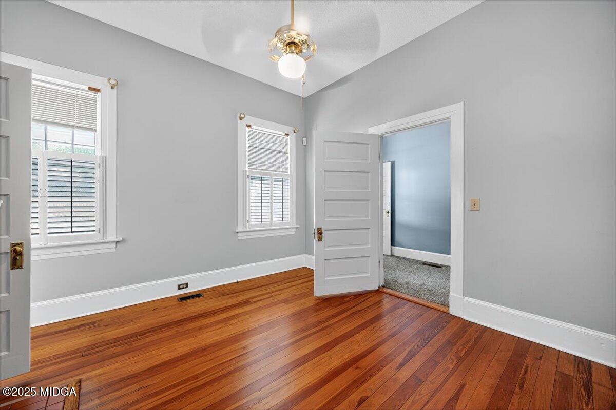 173 Pierce Avenue Macon, GA 31204 - Photo 10 of 20 wooden floor in an empty room with a window