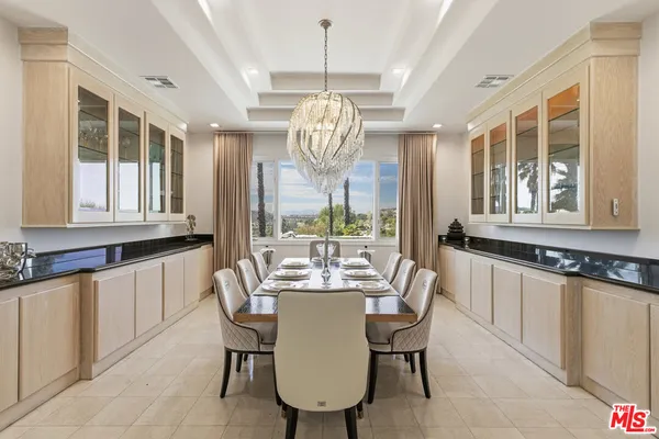a living room with stainless steel appliances furniture and a view of kitchen