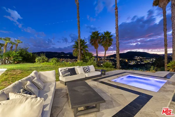a view of a patio with dining table and chairs with a fire pit