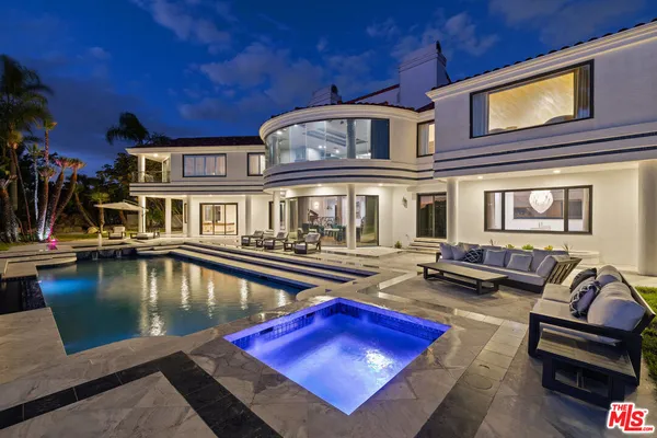 a living room with furniture pool table and chairs