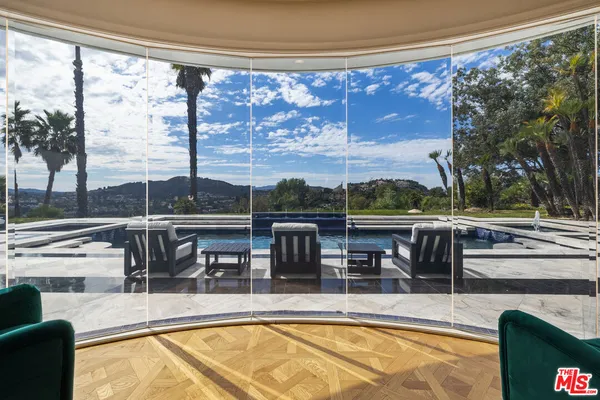 a view of a swimming pool with furniture