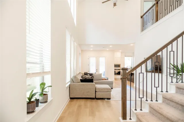 a living room with furniture and a potted plant next to a window