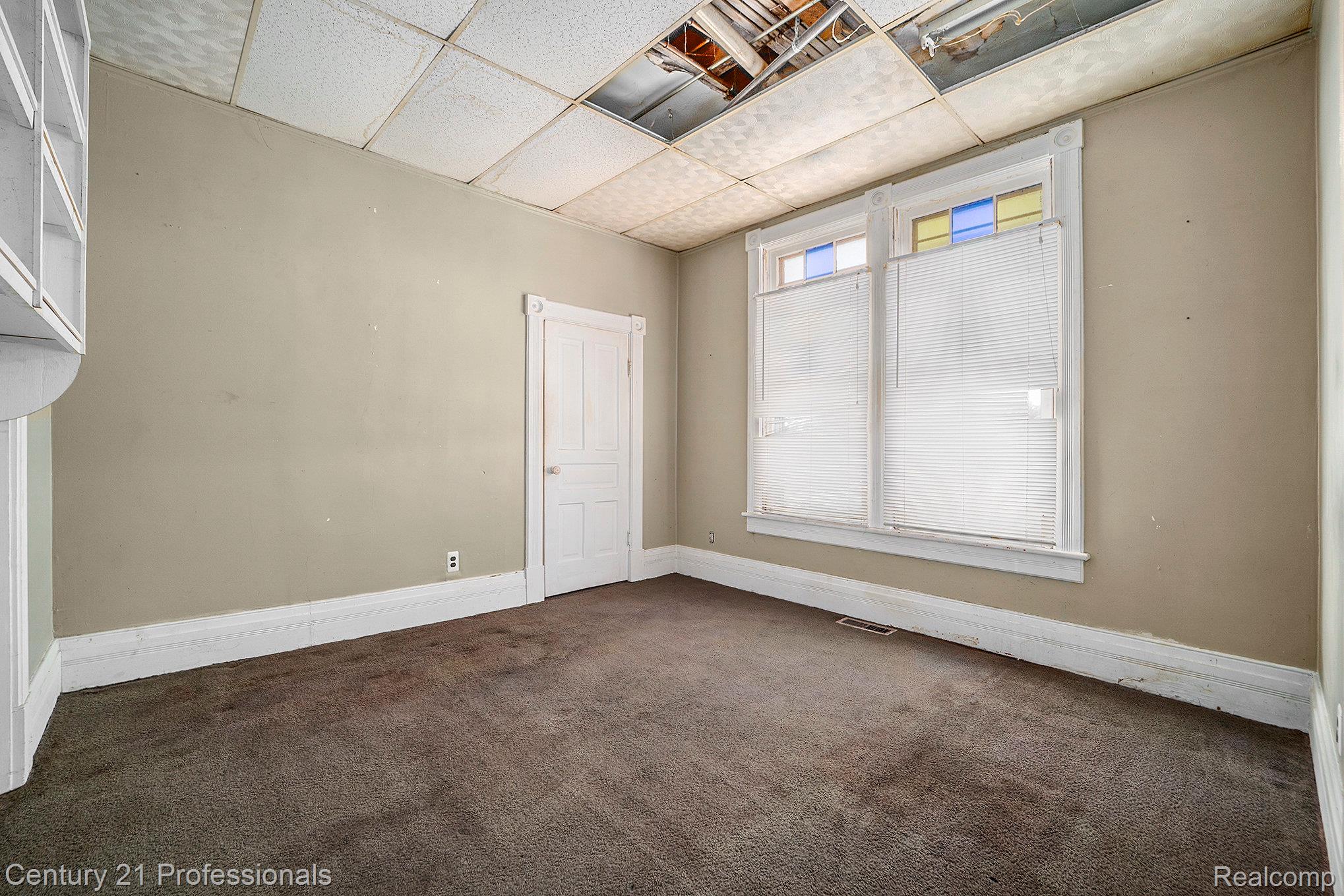 428 East Street Rochester, MI 48307 - Photo 24 of 30 Empty room with a paneled ceiling and carpet floors