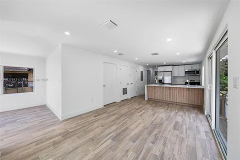 a view of kitchen and wooden floor