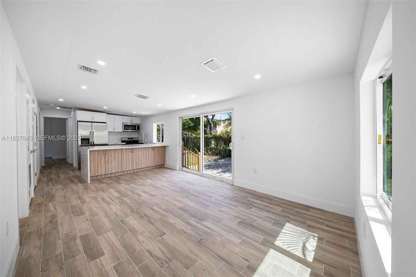5900 Northwest 5th Court Miami, FL 33127 - Photo 14 of 35 a view of kitchen with wooden floor and electronic appliances