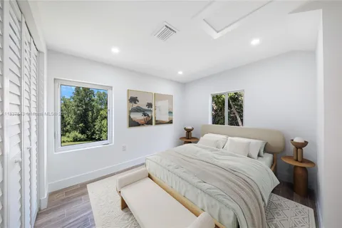 a bedroom with a large bed and a window