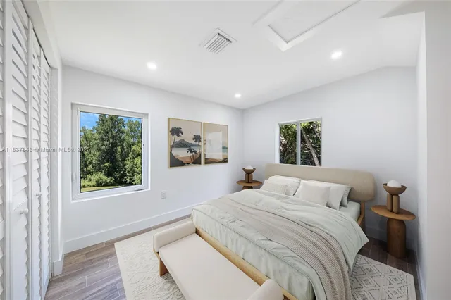 a bedroom with a large bed and a window