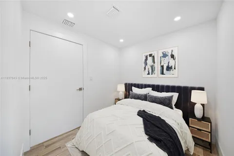 a bedroom with a bed and painting on the wall