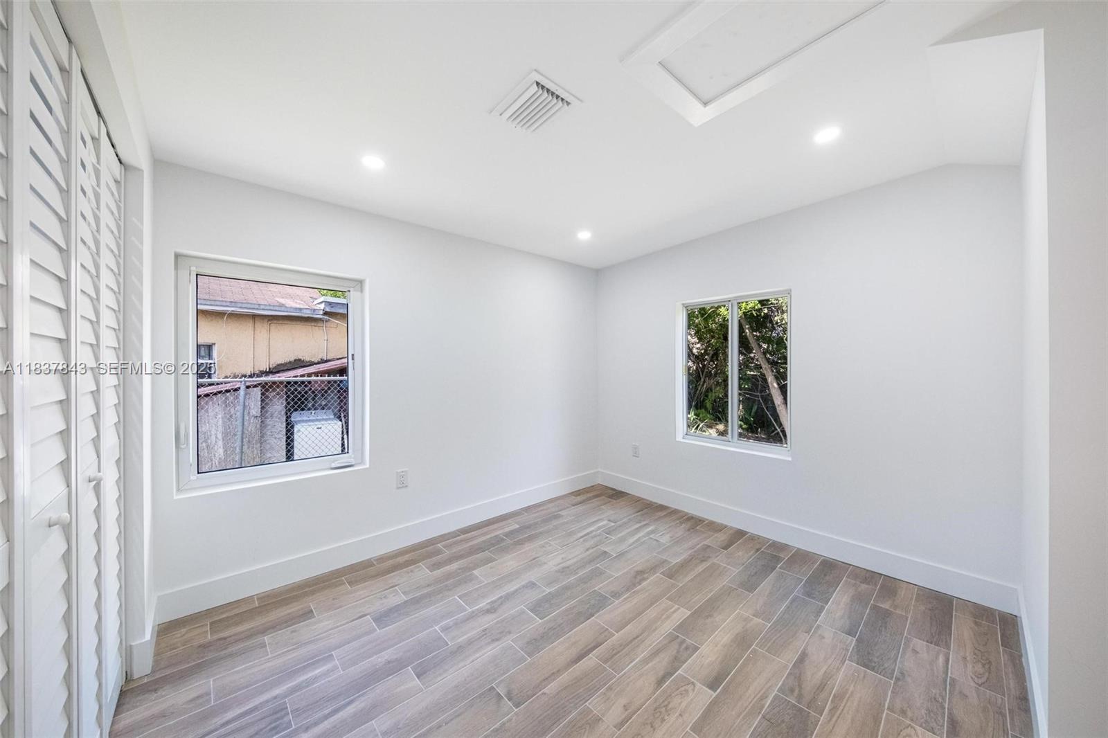 5900 Northwest 5th Court Miami, FL 33127 - Photo 22 of 35 an empty room with a window and wooden floor
