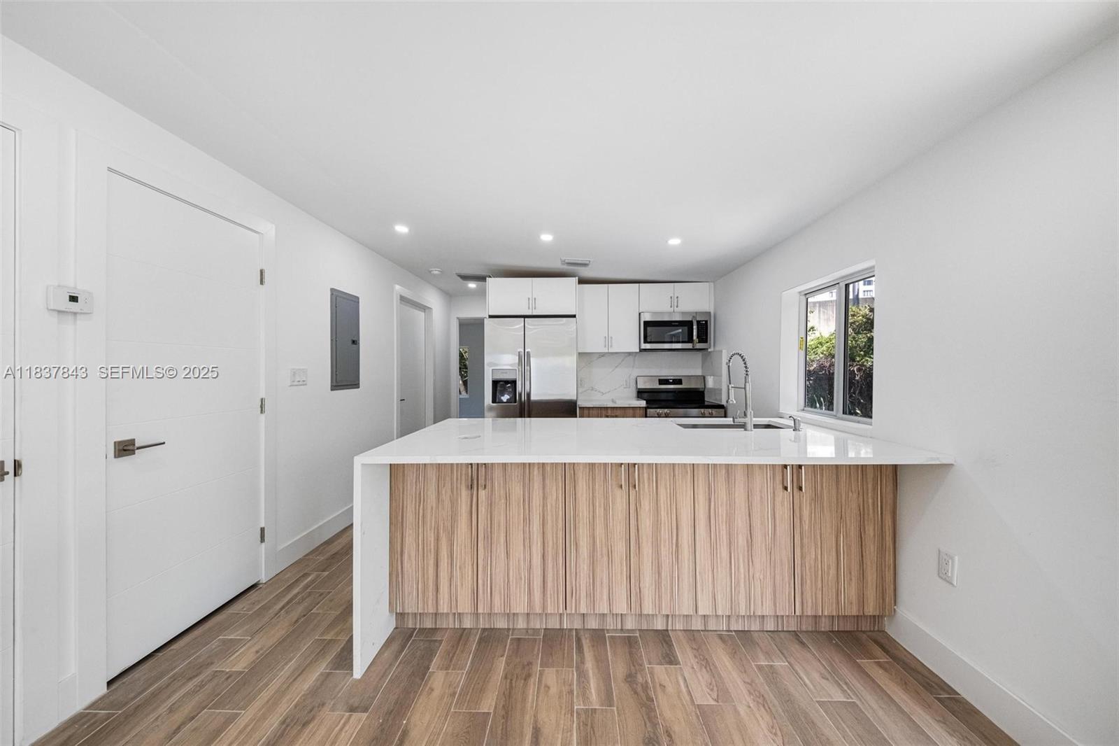5900 Northwest 5th Court Miami, FL 33127 - Photo 3 of 35 a living room with stainless steel appliances kitchen island wooden floor and view living room