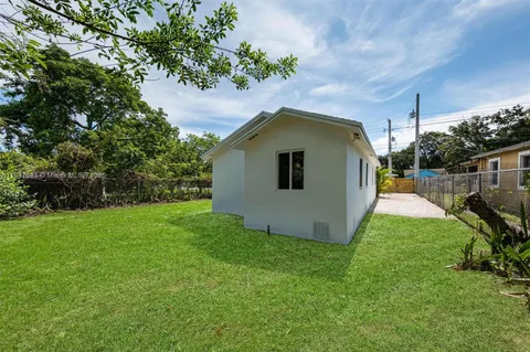 a view of a backyard with a house and garden