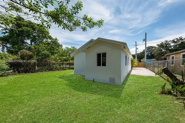 a view of a backyard with a house and garden
