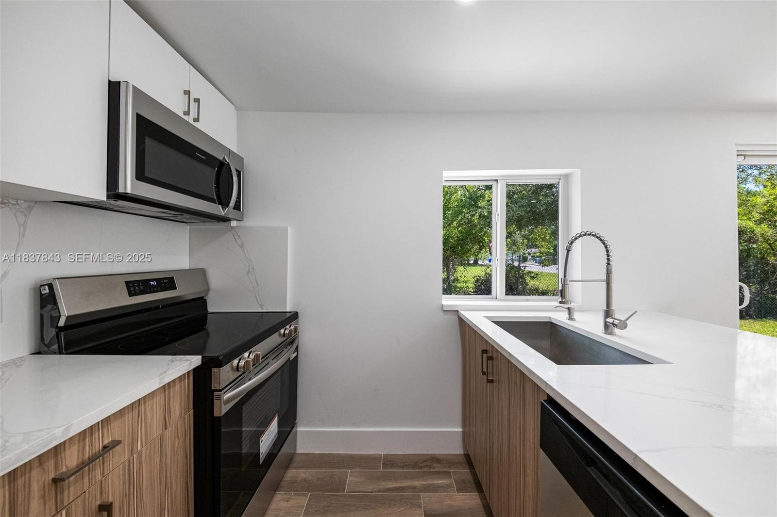 5900 Northwest 5th Court Miami, FL 33127 - Photo 4 of 35 a kitchen with a sink and steel appliances