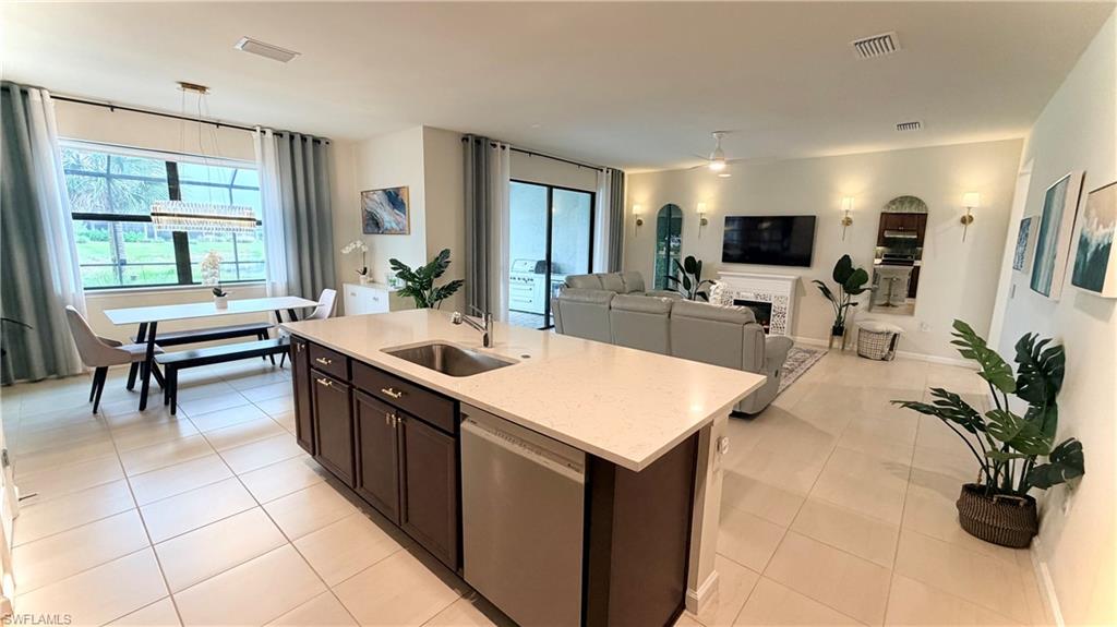 2085 Yellowfin Circle Naples, FL 34114 - Photo 48 of 50 a large kitchen with kitchen island a sink table and chairs