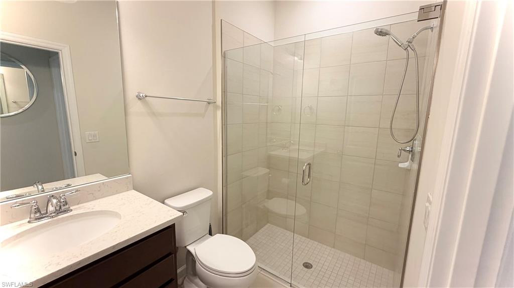 2085 Yellowfin Circle Naples, FL 34114 - Photo 15 of 50 a bathroom with a sink a toilet and shower