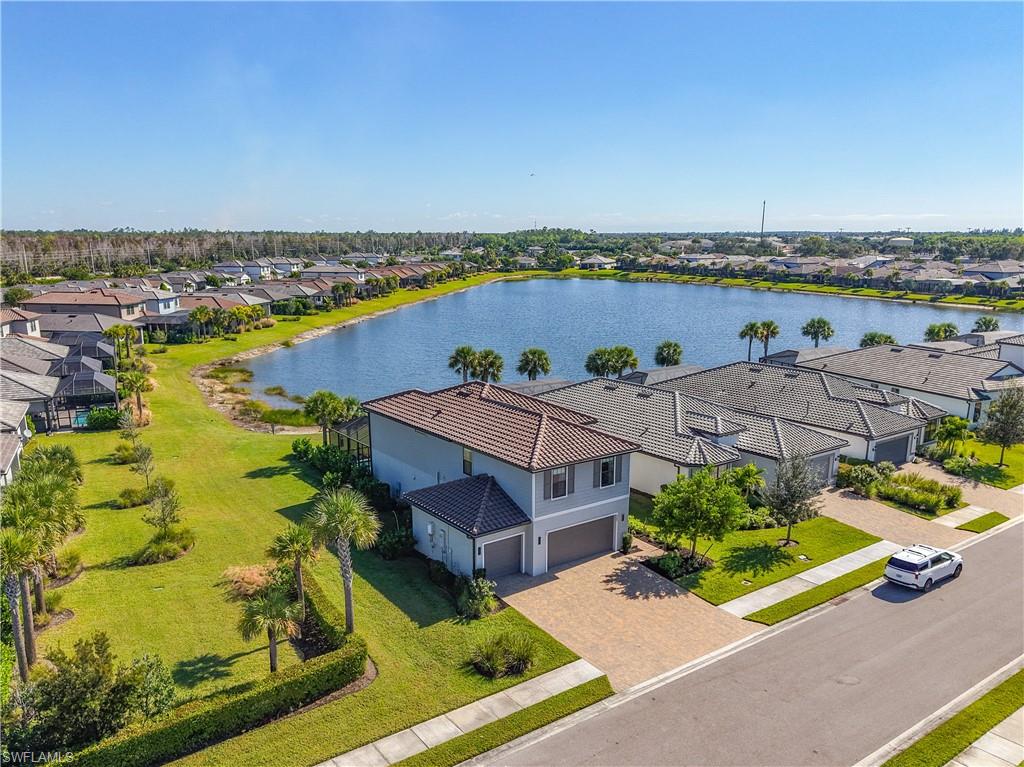 2085 Yellowfin Circle Naples, FL 34114 - Photo 2 of 50 an aerial view of a house with a garden and lake view