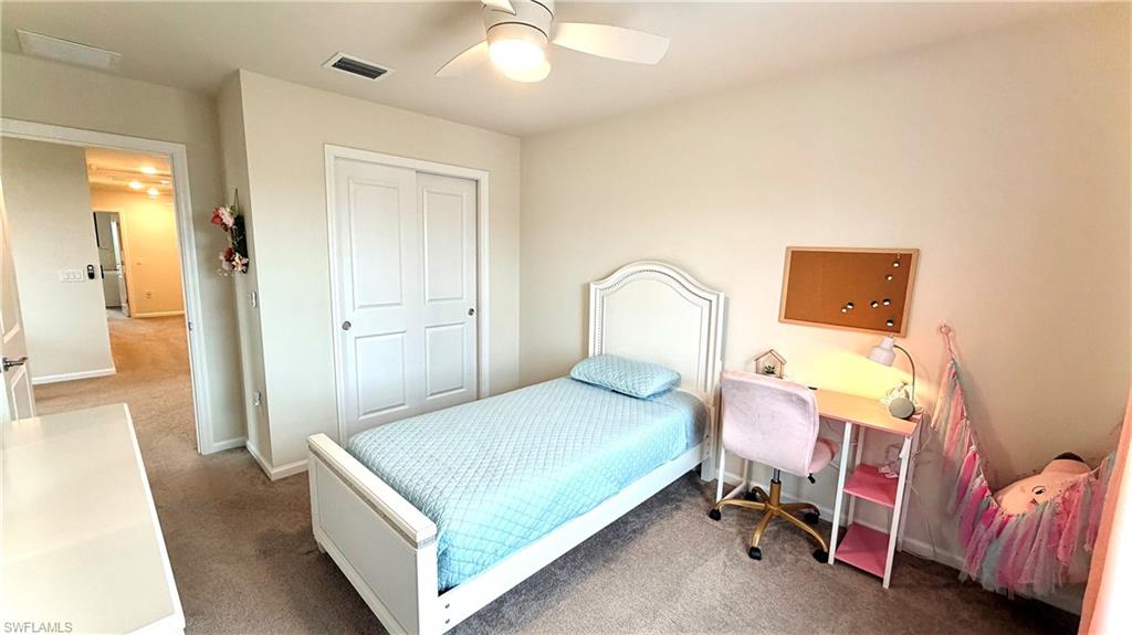 2085 Yellowfin Circle Naples, FL 34114 - Photo 22 of 50 a bedroom with a bed and a table