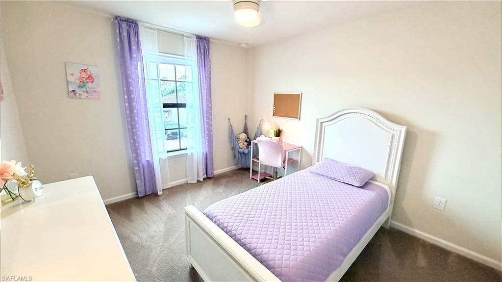 2085 Yellowfin Circle Naples, FL 34114 - Photo 23 of 50 a bedroom with a bed and wooden floor