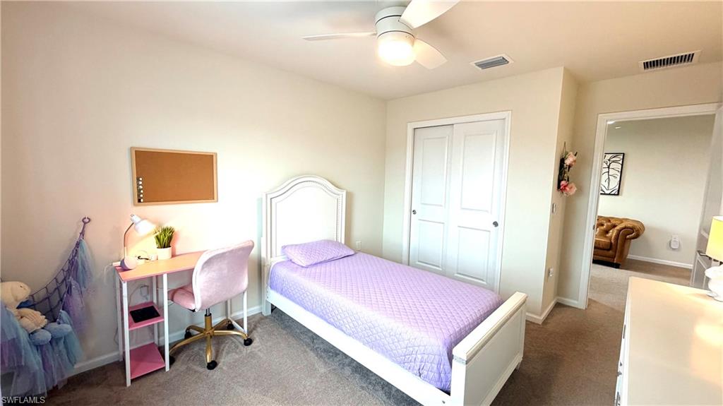 2085 Yellowfin Circle Naples, FL 34114 - Photo 24 of 50 a bedroom with a bed and a chandelier