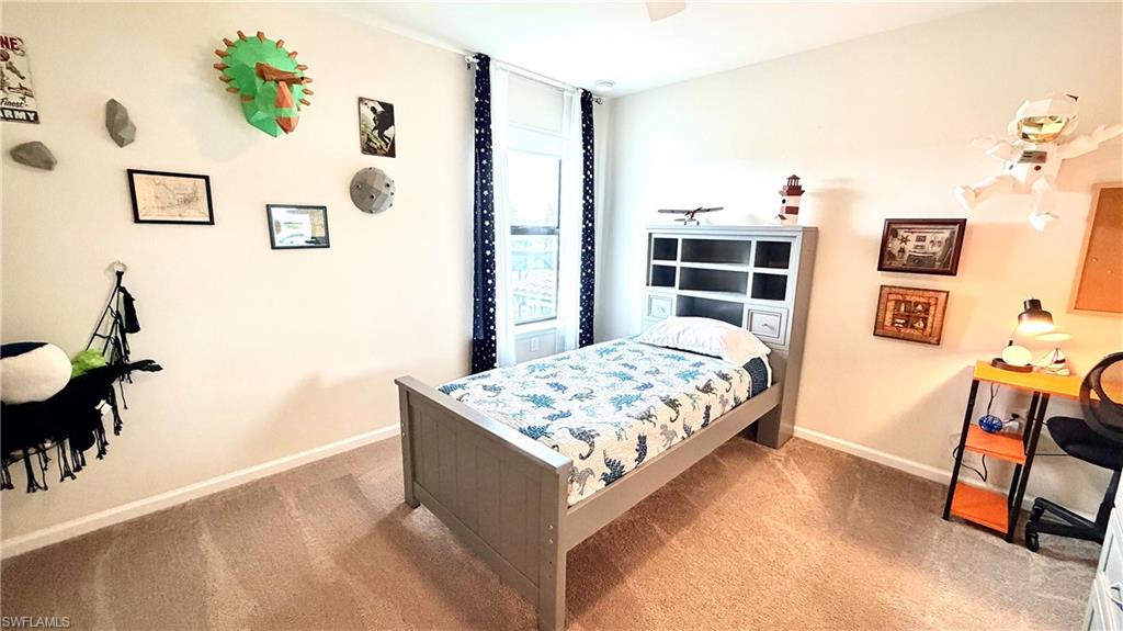 2085 Yellowfin Circle Naples, FL 34114 - Photo 26 of 50 a bedroom with a bed and a couch