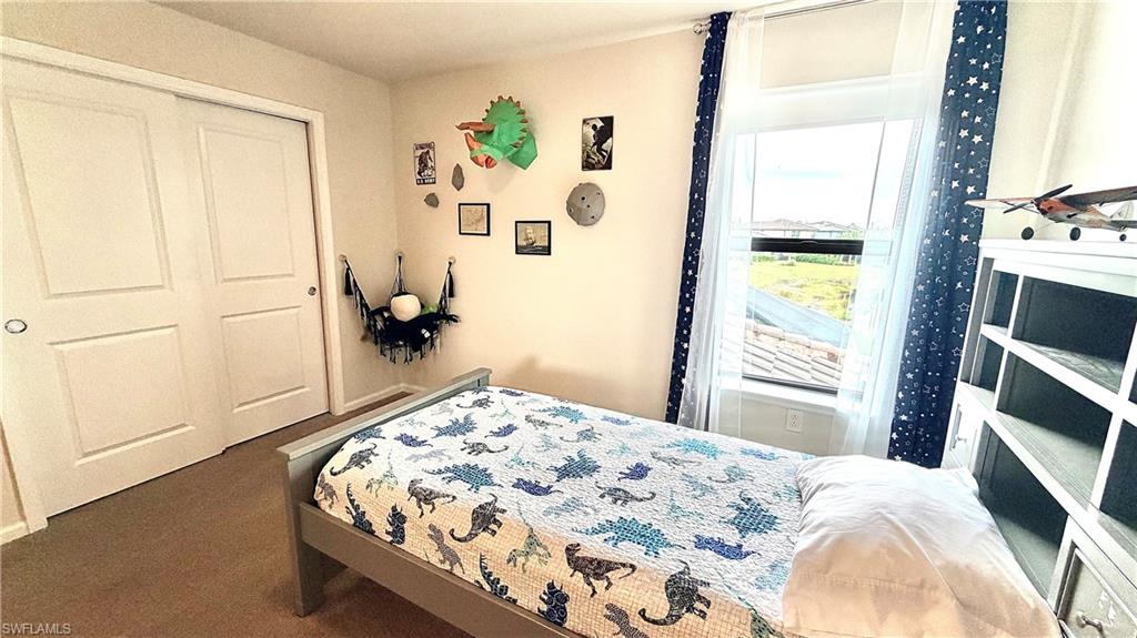 2085 Yellowfin Circle Naples, FL 34114 - Photo 27 of 50 a bedroom with a bed and a window