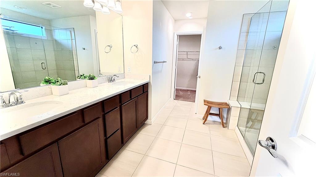 2085 Yellowfin Circle Naples, FL 34114 - Photo 33 of 50 a spacious bathroom with a double vanity sink mirror and shower
