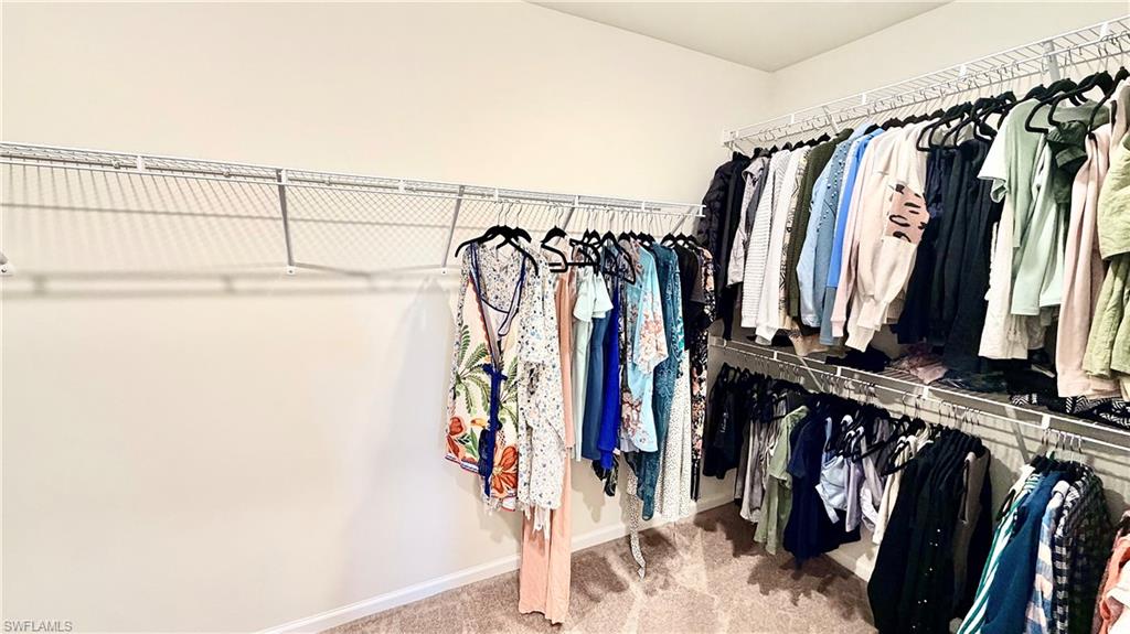 2085 Yellowfin Circle Naples, FL 34114 - Photo 34 of 50 a view of walk in closet with clothes