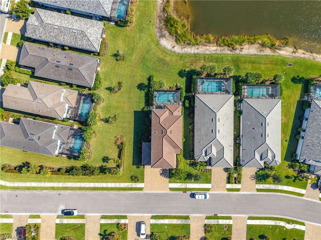 2085 Yellowfin Circle Naples, FL 34114 - Photo 42 of 50 an aerial view of residential houses with outdoor space and parking