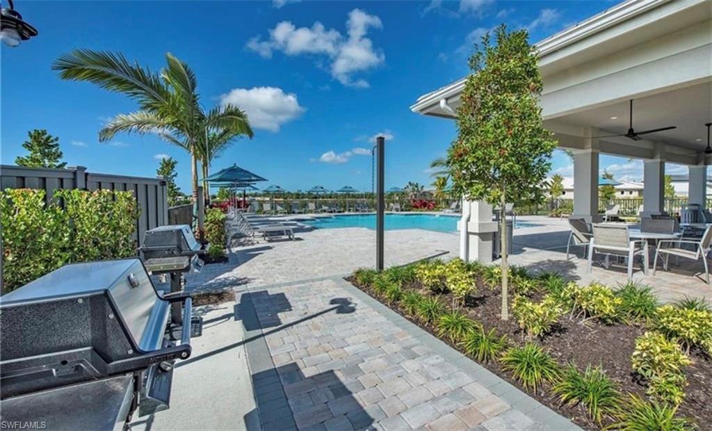 2085 Yellowfin Circle Naples, FL 34114 - Photo 45 of 50 a view of a porch with a table and chairs