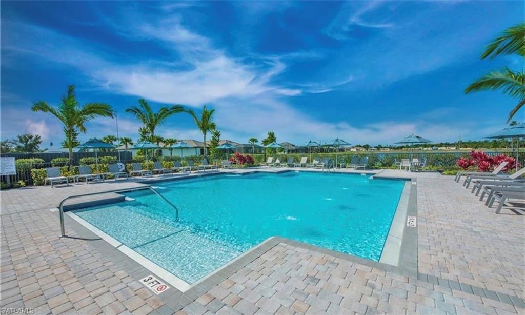 2085 Yellowfin Circle Naples, FL 34114 - Photo 46 of 50 a view of a lake with a house in the background