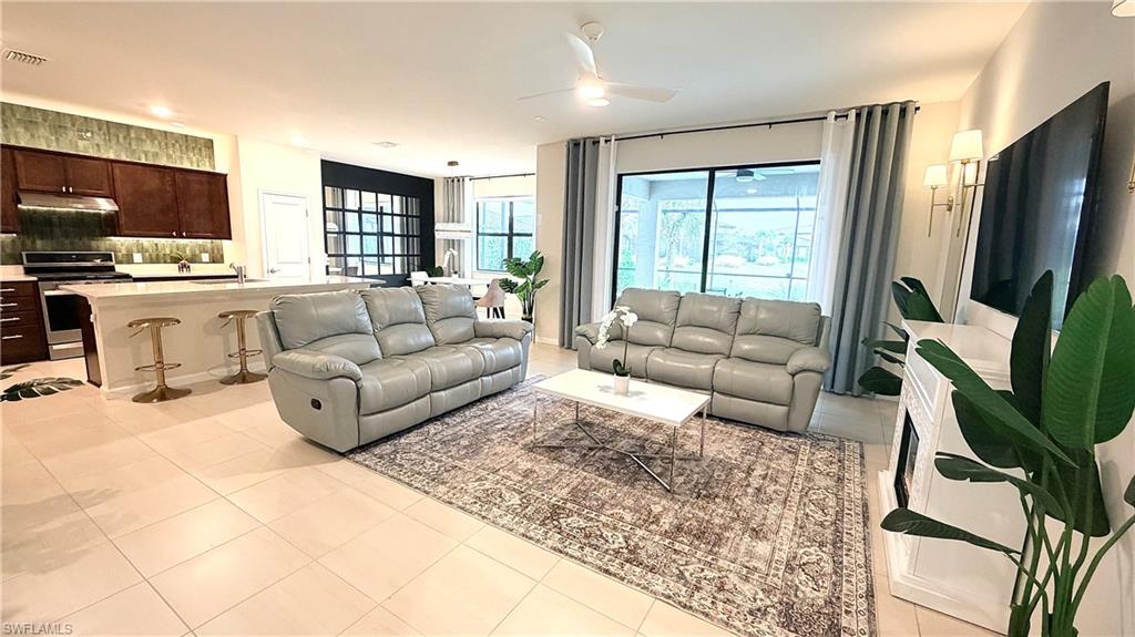 2085 Yellowfin Circle Naples, FL 34114 - Photo 5 of 50 a living room with furniture fireplace and flat screen tv