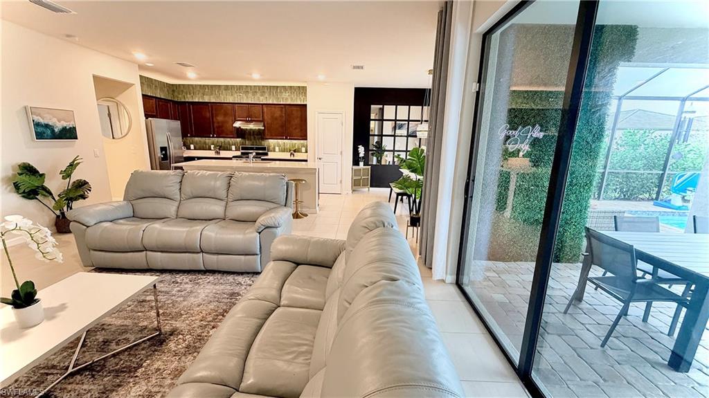 2085 Yellowfin Circle Naples, FL 34114 - Photo 6 of 50 a living room with furniture and a flat screen tv