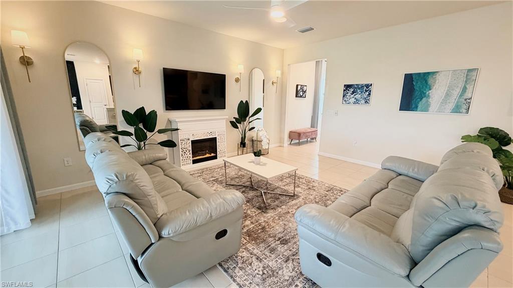 2085 Yellowfin Circle Naples, FL 34114 - Photo 7 of 50 a living room with furniture and a flat screen tv