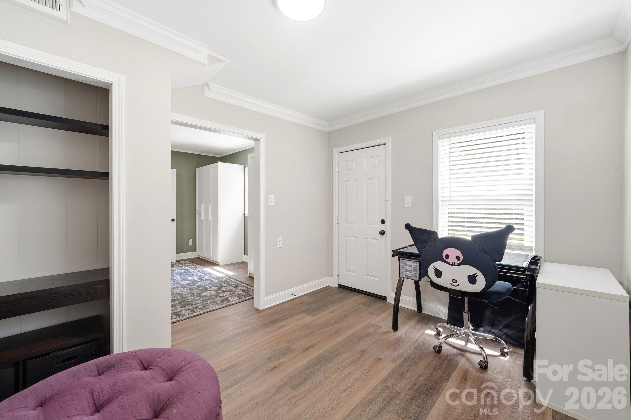 7552 Idlewild Road Charlotte, NC 28212 - Photo 23 of 40 a bedroom with furniture and a window