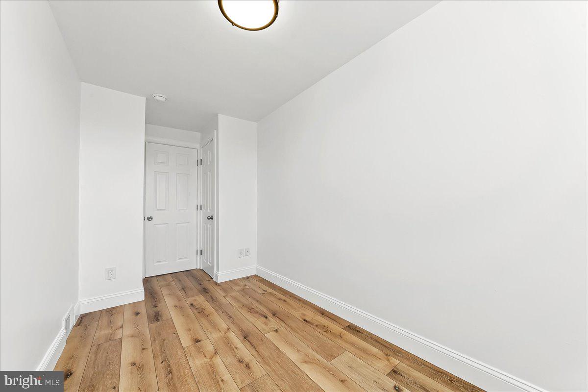 1232 Edgehill Road Darby, PA 19023 - Photo 16 of 20 a view of a room with wooden floor and white walls