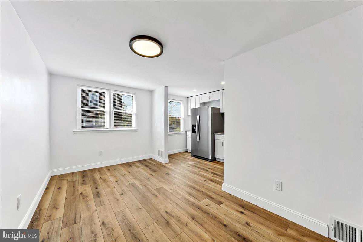1232 Edgehill Road Darby, PA 19023 - Photo 6 of 20 a view of an empty room with wooden floor and a window