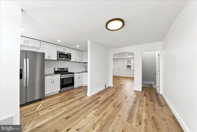 a kitchen with stainless steel appliances a refrigerator stove and microwave