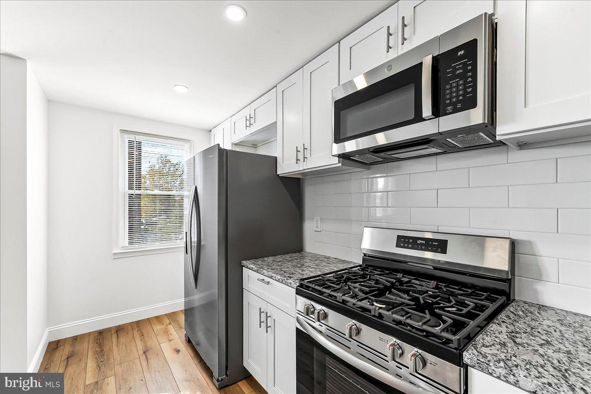 1232 Edgehill Road Darby, PA 19023 - Photo 10 of 20 a kitchen with stainless steel appliances granite countertop a stove and a microwave