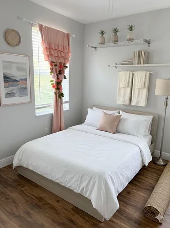 a bedroom with a bed and a window