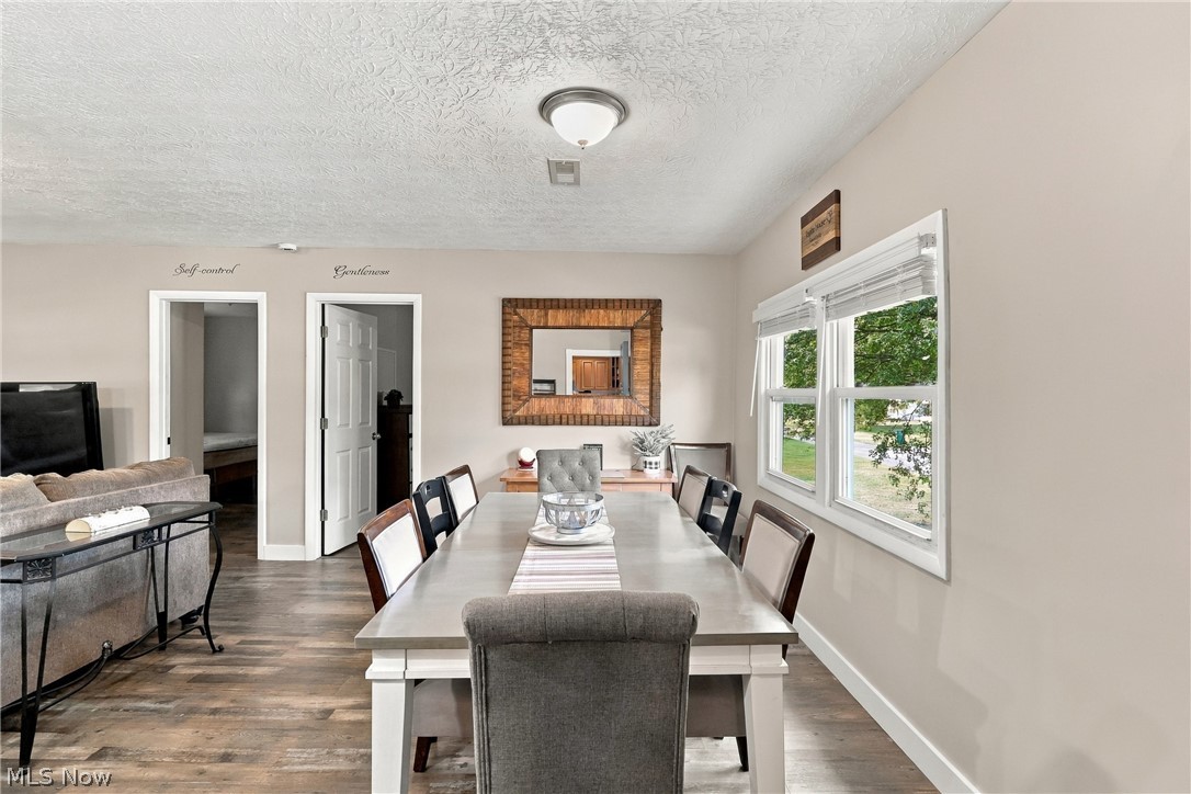 1875 Perth Road Madison, OH 44057 - Photo 10 of 48 Wood-finish flooring throughout, light neutral wall paint, white trim, and two paneled interior doors