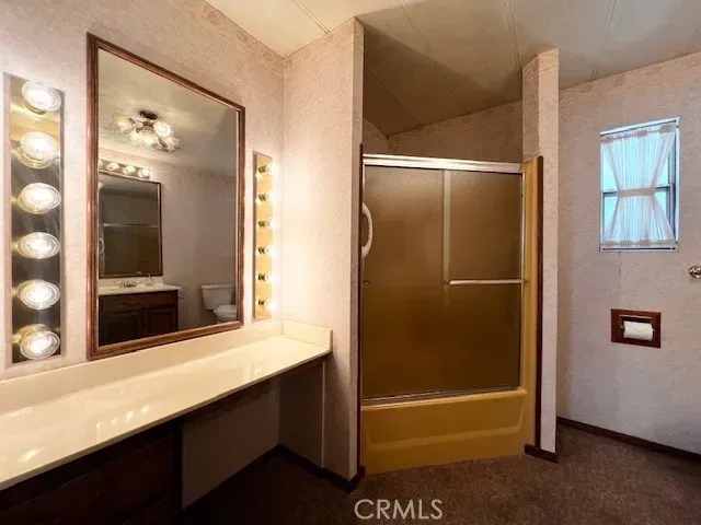 a bathroom with a shower and mirror