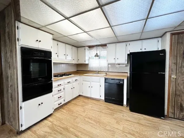 a kitchen with cabinets and stainless steel appliances