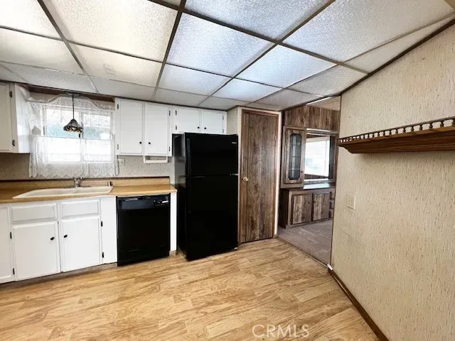 a kitchen with a refrigerator and a sink